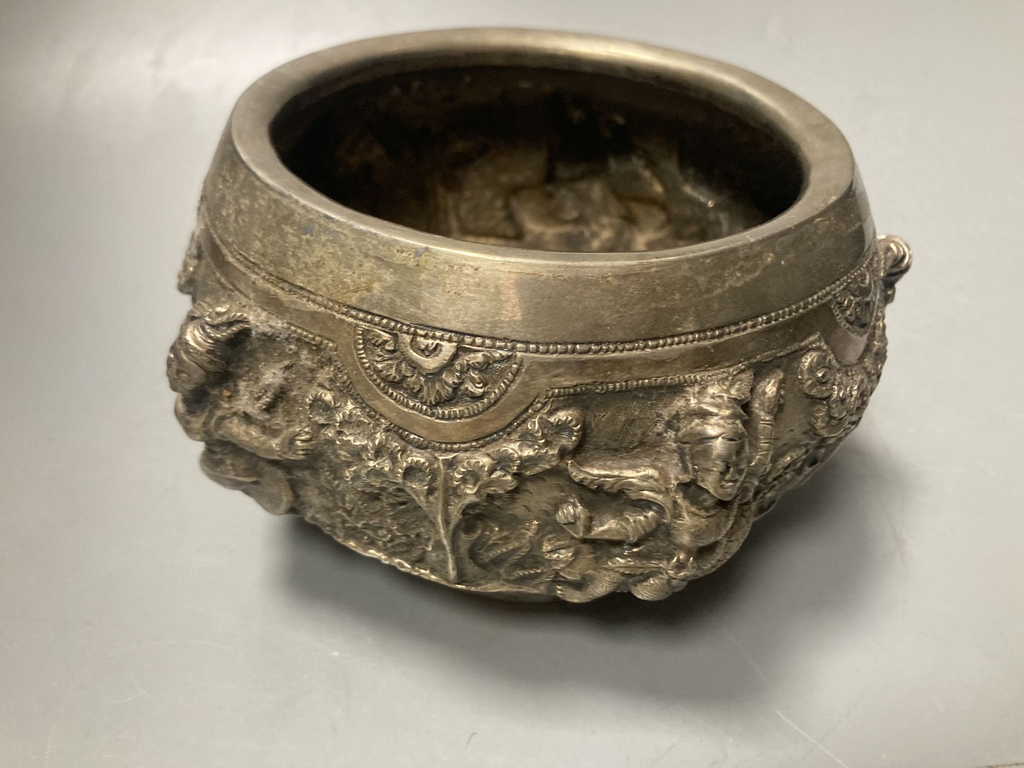 A small Burmese white metal bowl, embossed with deities, repaired, width 15.5c m, gross 10 oz.